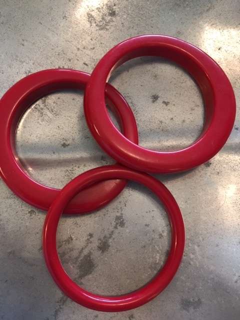 Three bright red bangles