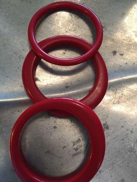 Three bright red bangles