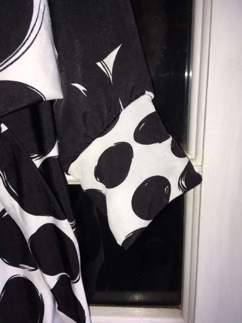 Bold black and white polka dot print 3/4 sleeve top