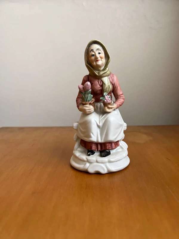 Antique porcelain statue - old lady with flowers