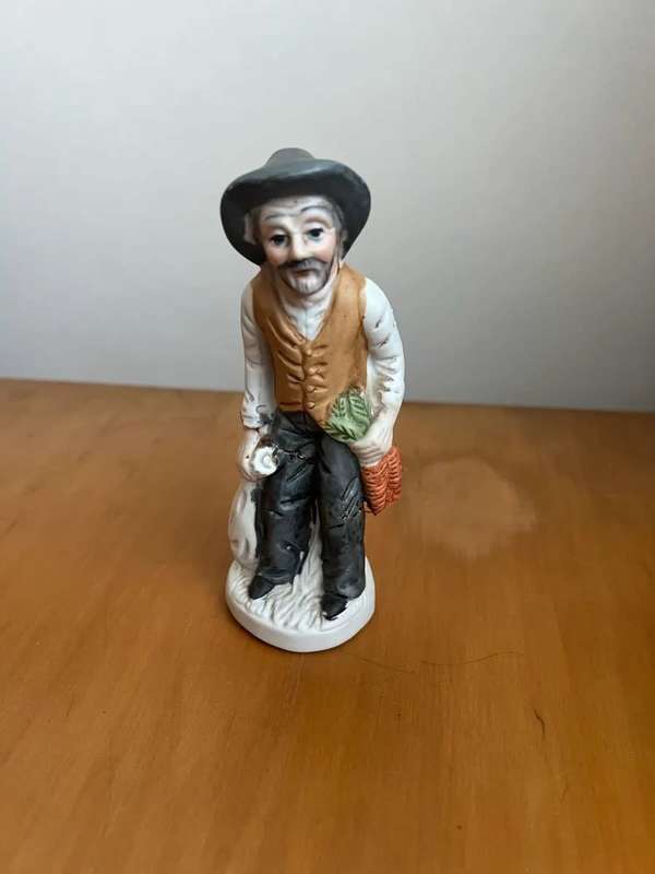 Antique porcelain statue - man holding carrots