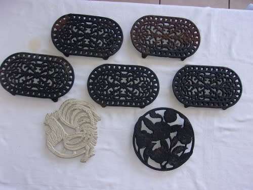 7 Decorative footed cast iron trivets for 1 bid