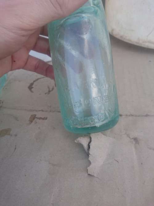 Two antique Port Elizabeth bottles with marble