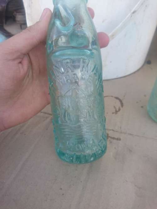 Two antique Port Elizabeth bottles with marble
