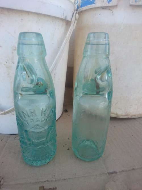 Two antique Port Elizabeth bottles with marble