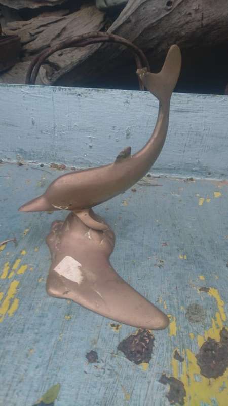 Brass dolphin damaged to tail