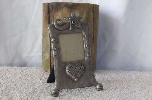 A HEART WARMING CARROL BOYES STYLE METAL FRAME WITH MAKERS MARKS AND DATED 1997