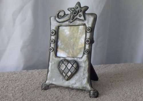 A HEART WARMING CARROL BOYES STYLE METAL FRAME WITH MAKERS MARKS AND DATED 1997