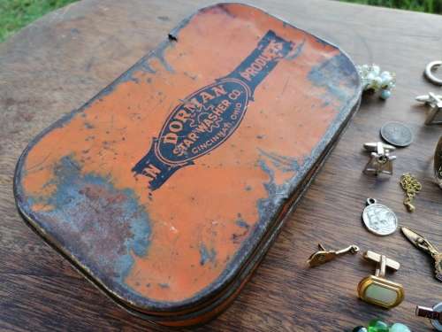 AN OLD TIN WITH BITS AND BOBS