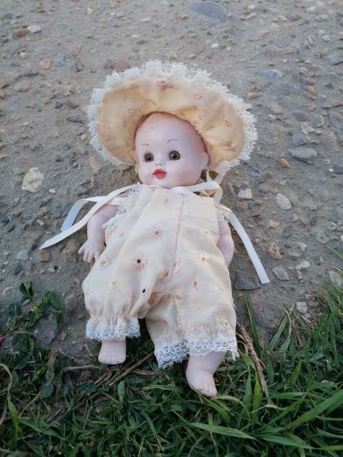 Cute porcelain doll attached by string