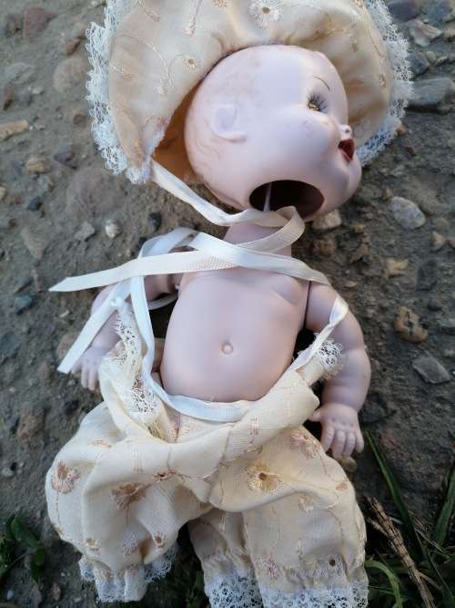 Cute porcelain doll attached by string