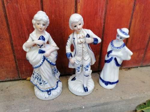 3 porcelain figures. Boy neck repaired and chip to front boot