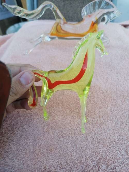 2 murano glass horses. Small one Missing a leg large one small chip on edge of tail