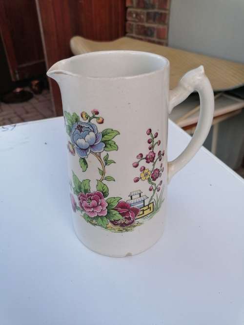 Antique porcelain pitcher. Have some chips