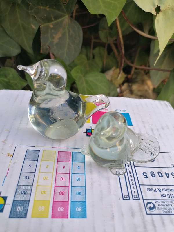 Two paper weights. The smaller one have a small chip