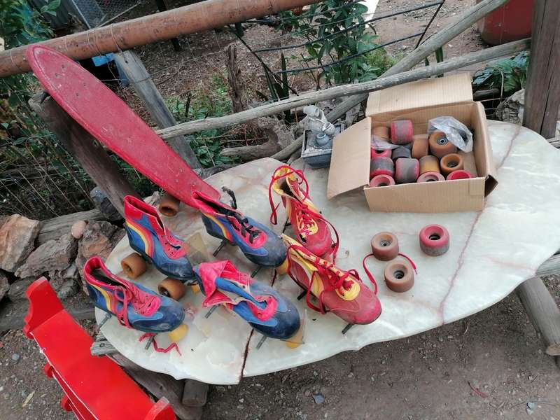 Vintage roller skates and skateboard with lots of wheels. Needs attention