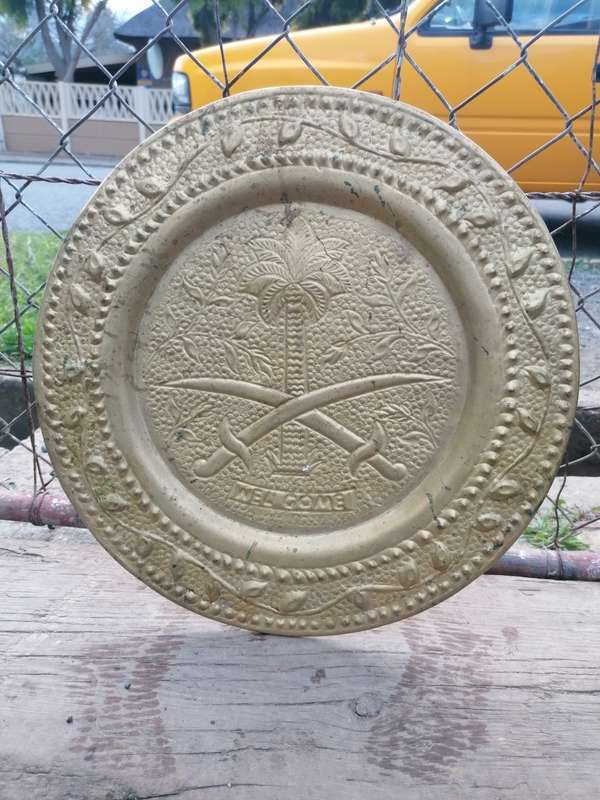plate with the Qatari state emblem hanging