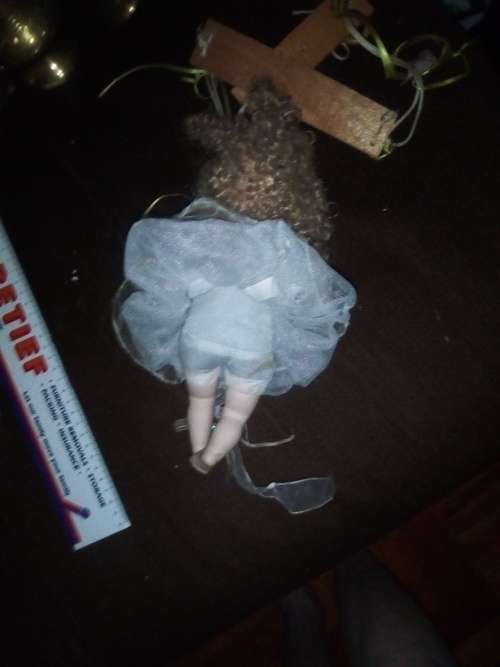 PORCELAIN DOLL ON SWING