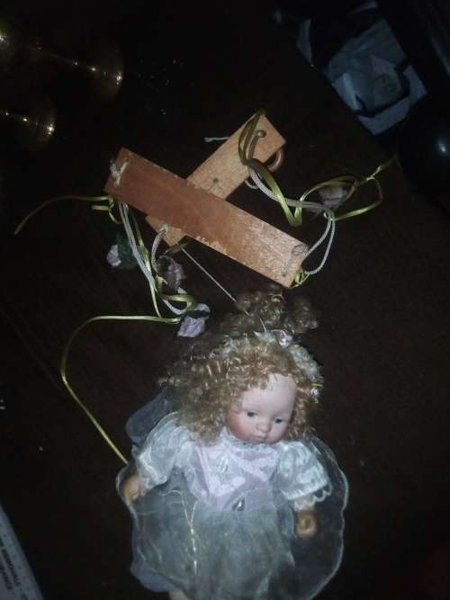 PORCELAIN DOLL ON SWING