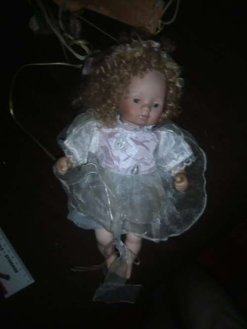 PORCELAIN DOLL ON SWING