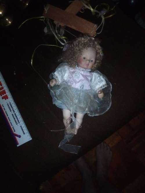 PORCELAIN DOLL ON SWING