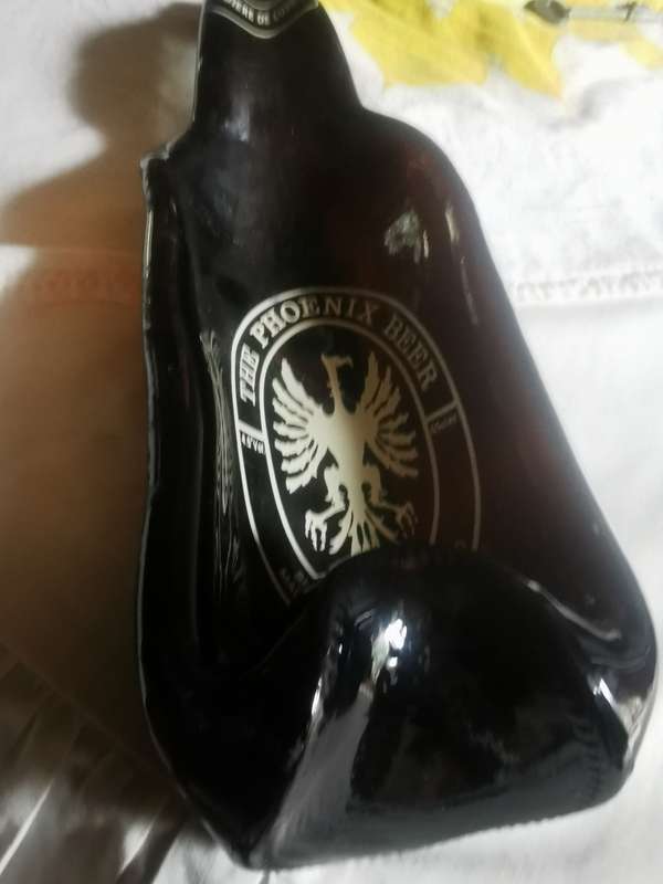 Unusual shaped glass beer bottle