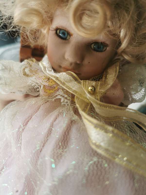 VINTAGE SMALL PORCELAIN DOLL ON ANTIQUE CHAIR