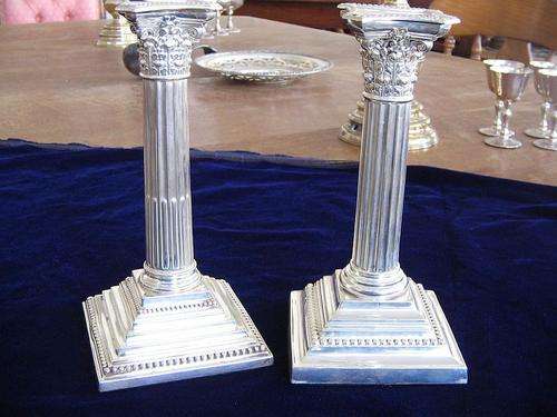 Pair of miss matched silver candlesticks