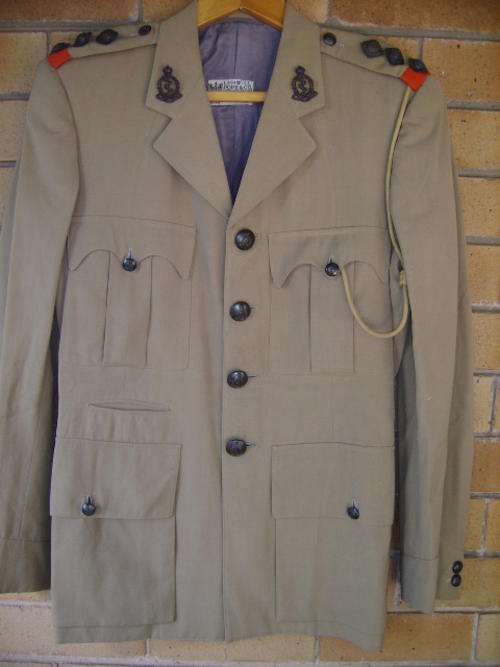 A WWII-CAPTAINS-KHAKI TUNIC-(S.A.M.C).-NAME ON LABEL-CAPTAIN WATSON-WITH ALL INSIGNIA WITH LANYARD-.