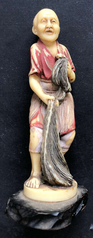 EASTERN FIGURE OF FISHERMAN WITH NET MOULDED