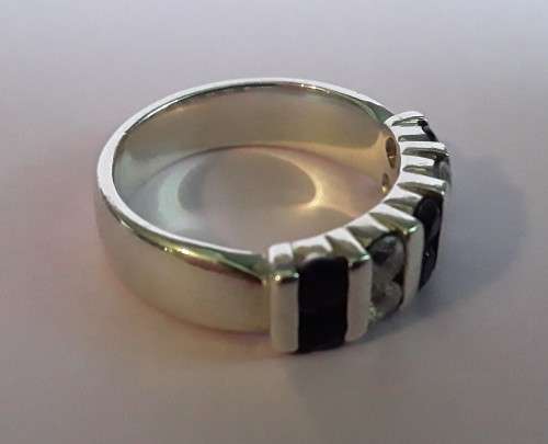 Lovely solid sterling silver ring with clear and purple stones.