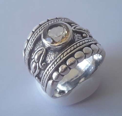 Solid sterling silver wide band ring with faceted citrine coloured stone.  Size: O.  Weight: 13.6g