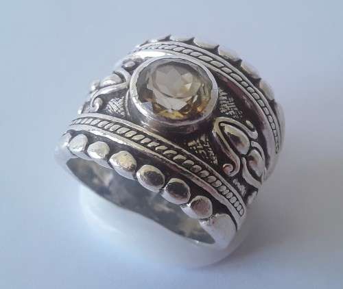 Solid sterling silver wide band ring with faceted citrine coloured stone.  Size: O.  Weight: 13.6g