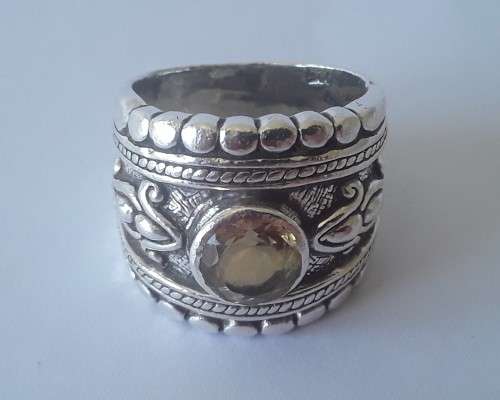 Solid sterling silver wide band ring with faceted citrine coloured stone.  Size: O.  Weight: 13.6g