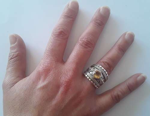 Solid sterling silver wide band ring with faceted citrine coloured stone.  Size: O.  Weight: 13.6g