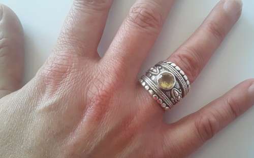 Solid sterling silver wide band ring with faceted citrine coloured stone.  Size: O.  Weight: 13.6g