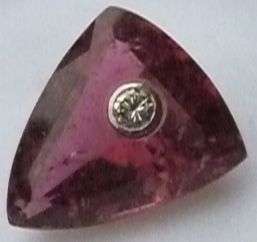 PURPLE GEMSTONE WITH INSERTED +/- 0.10 CT DIAMOND.