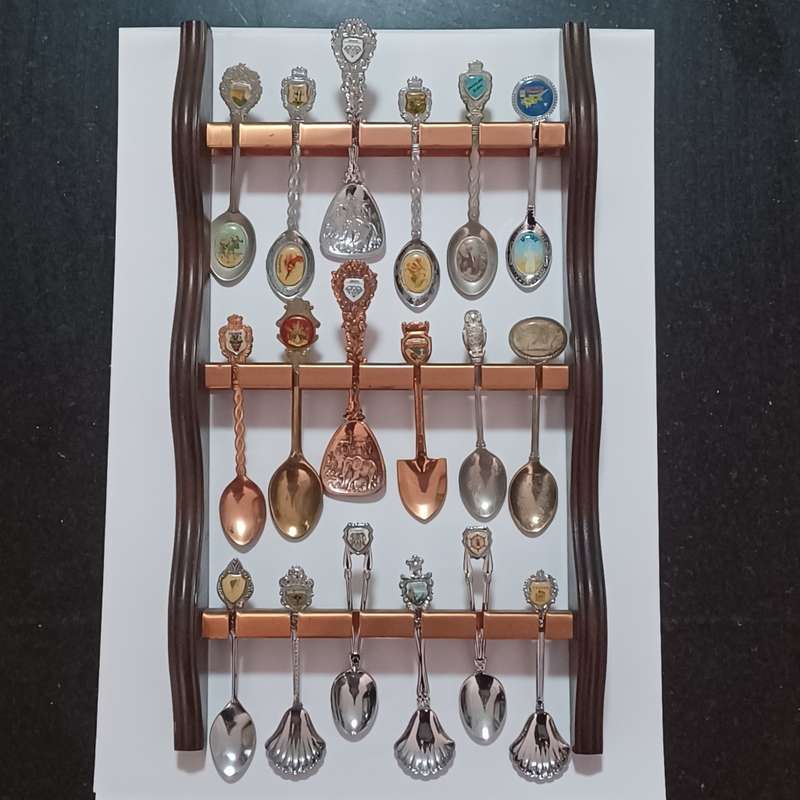 Vintage collectable spoons on wall stand