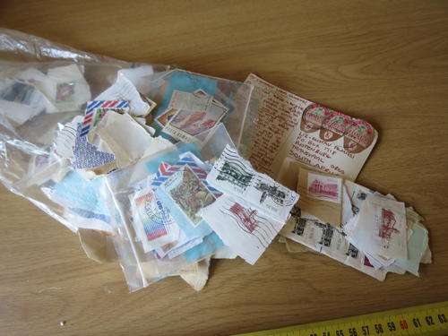 bag of used stamps on piece, as per photo