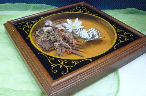 A BIT OF ART IN A WOODEN FRAME AND GLASS