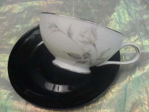 ODD PORCELAIN CUP AND SAUCER