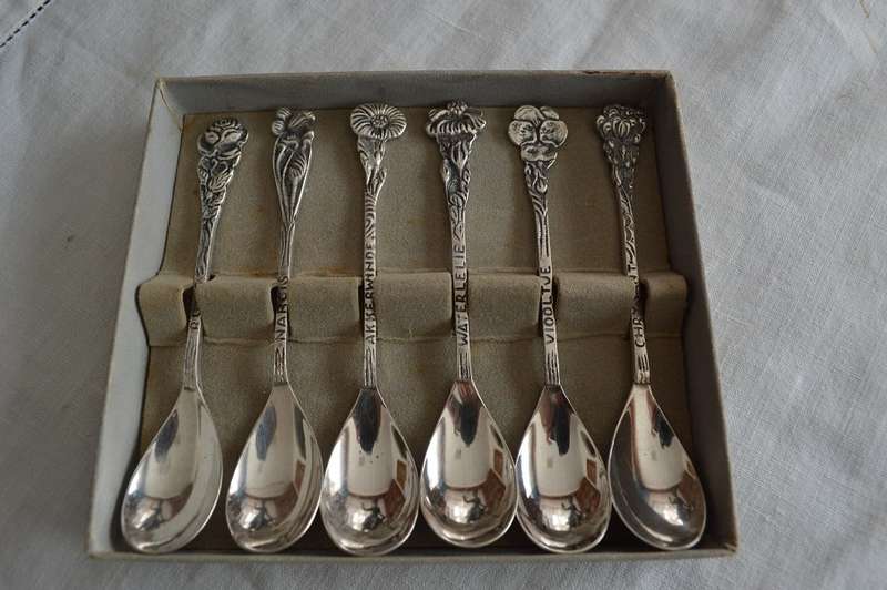 6 silver plated demitasse teaspoons with a different flower on the end of each handle,Very pretty !