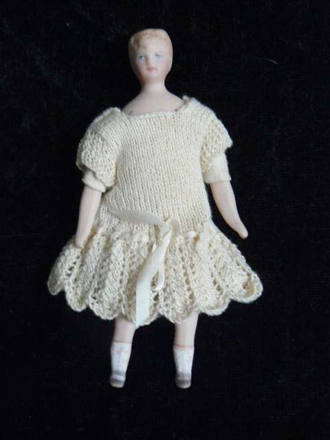 STUNNING MINIATURE PORCELAIN DOLL WITH HAND MADE DRESS
