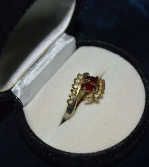 SILVER TONED RING WITH RED STONE