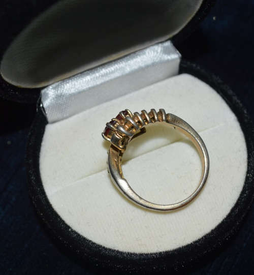 SILVER TONED RING WITH RED STONE