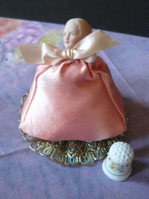 PIN CUSHION LADY WITH PORCELAIN HEAD AND A FREE THIMBLE