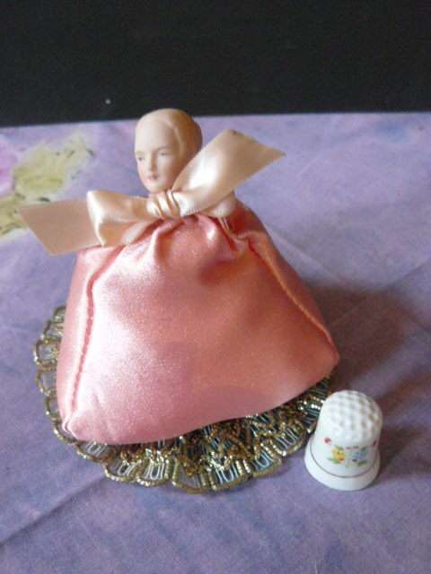 PIN CUSHION LADY WITH PORCELAIN HEAD AND A FREE THIMBLE