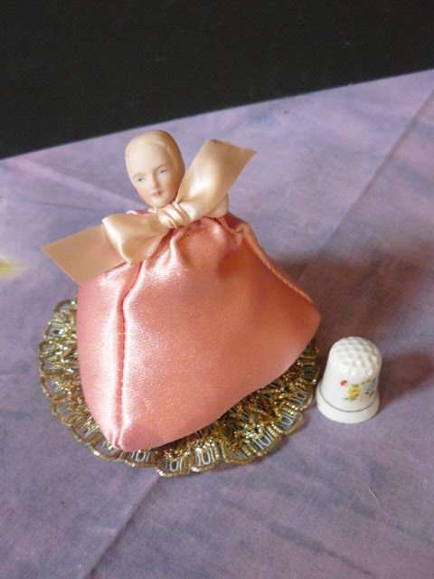 PIN CUSHION LADY WITH PORCELAIN HEAD AND A FREE THIMBLE