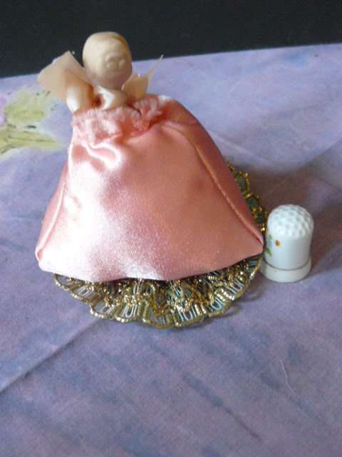PIN CUSHION LADY WITH PORCELAIN HEAD AND A FREE THIMBLE