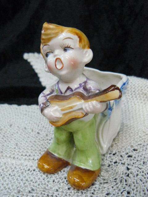 CERAMIC BOY FIGURINE WITH BASKET